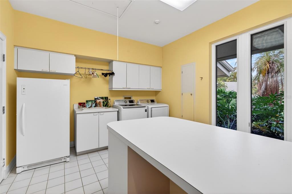 1571 Harbor Cay Lane Longboat Key, FL 34228 - Photo 44 of 93 a kitchen with a refrigerator a sink and cabinets