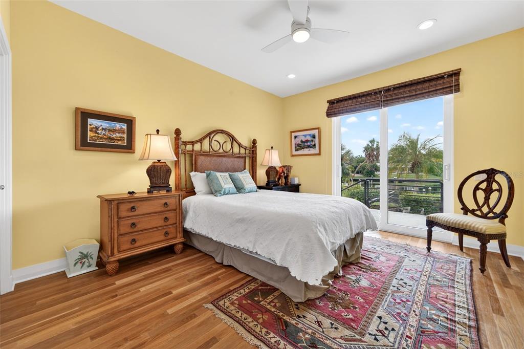 1571 Harbor Cay Lane Longboat Key, FL 34228 - Photo 51 of 93 a bedroom with a bed and a chair