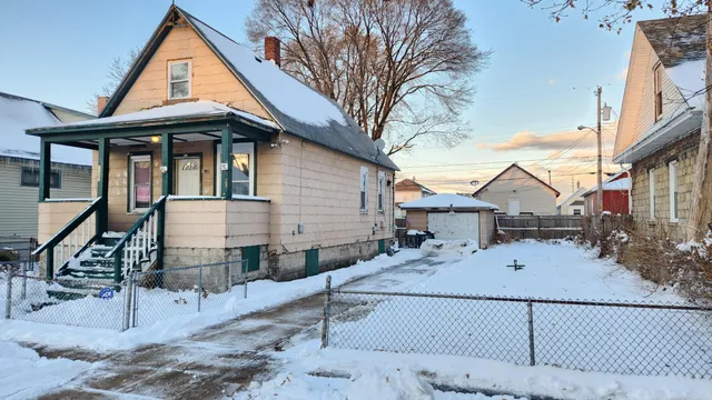 a view of a house with wooden fence