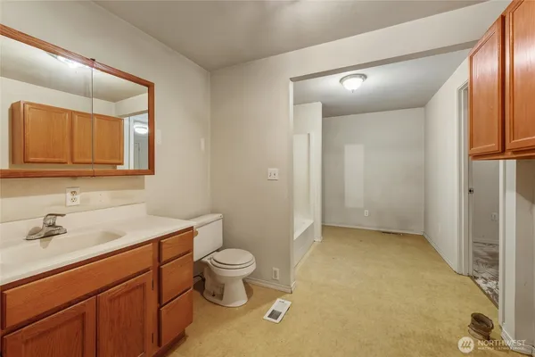 a bathroom with a sink a toilet and mirror