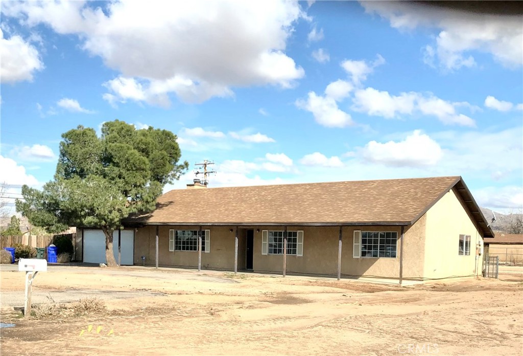 12885 Chief Joseph Road Apple Valley, CA 92308 - Photo 1 of 1 a house with trees in front of it