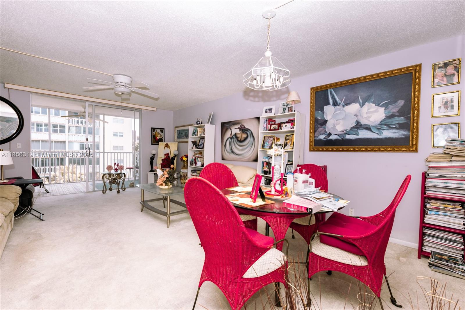 a view of a dining room with furniture a chandelier and a window