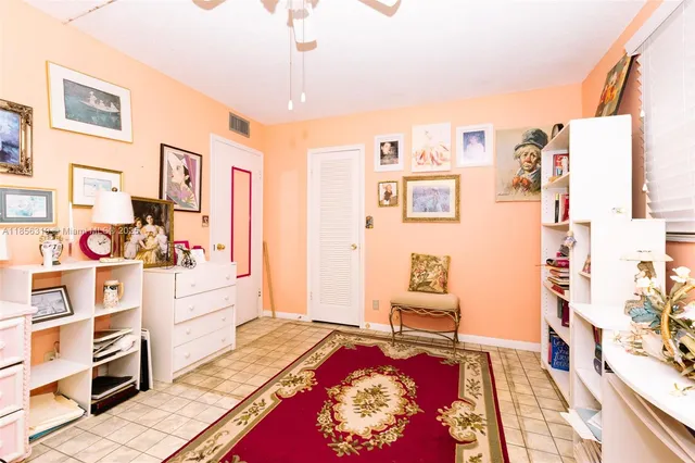 a living room with furniture cabinets and rug
