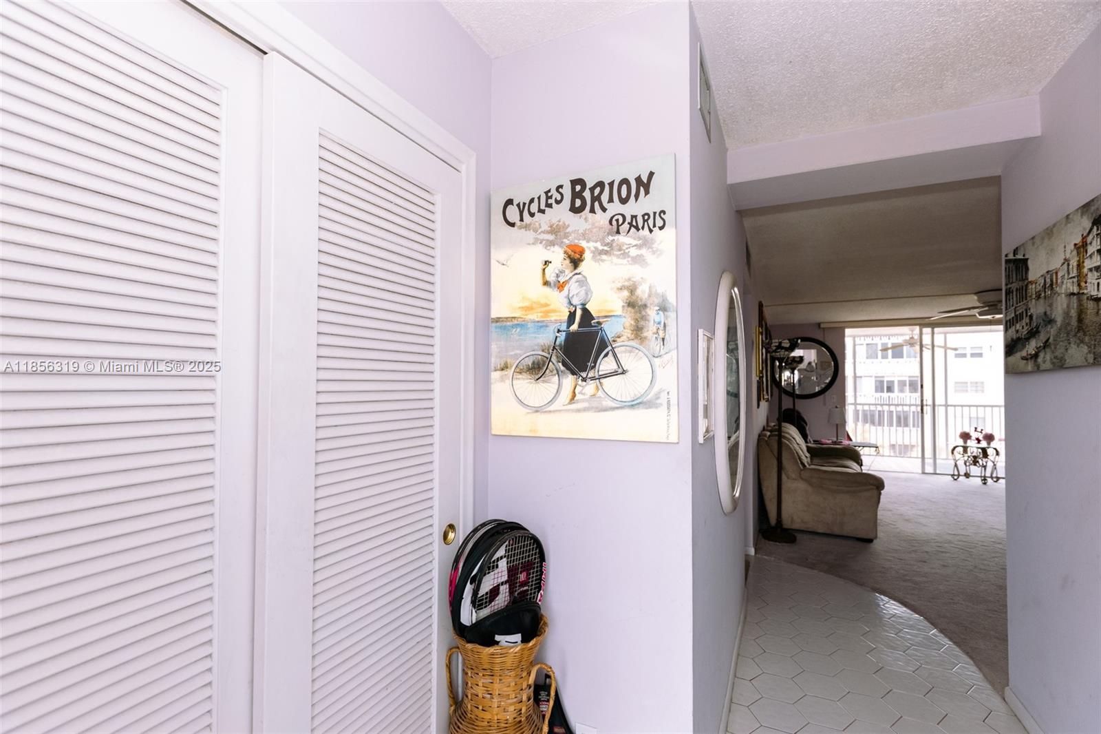 619 Northeast 14th Avenue, Unit 507 Hallandale Beach, FL 33009 - Photo 20 of 31 a view of a hallway with couches and painted walls
