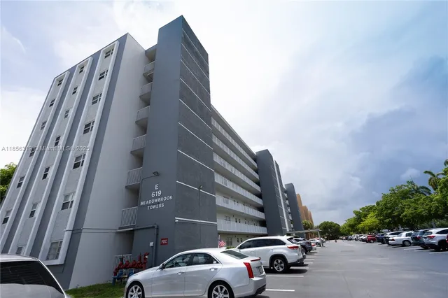 a view of a house with a backyard and a tree
