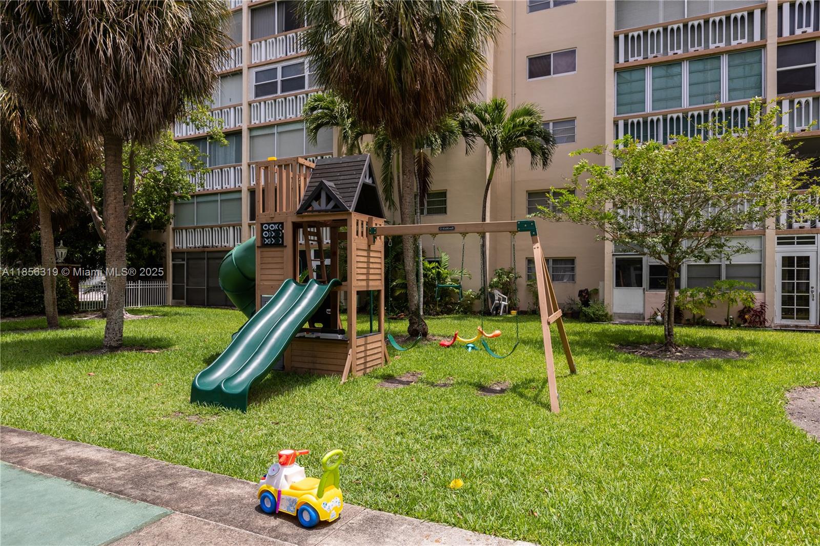 619 Northeast 14th Avenue, Unit 507 Hallandale Beach, FL 33009 - Photo 26 of 31 a view of a house with a backyard and a tree
