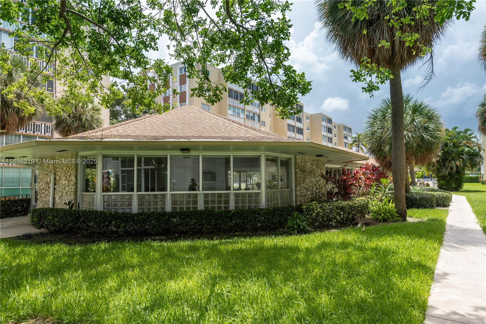 619 Northeast 14th Avenue, Unit 507 Hallandale Beach, FL 33009 - Photo 29 of 31 a front view of a house with a garden