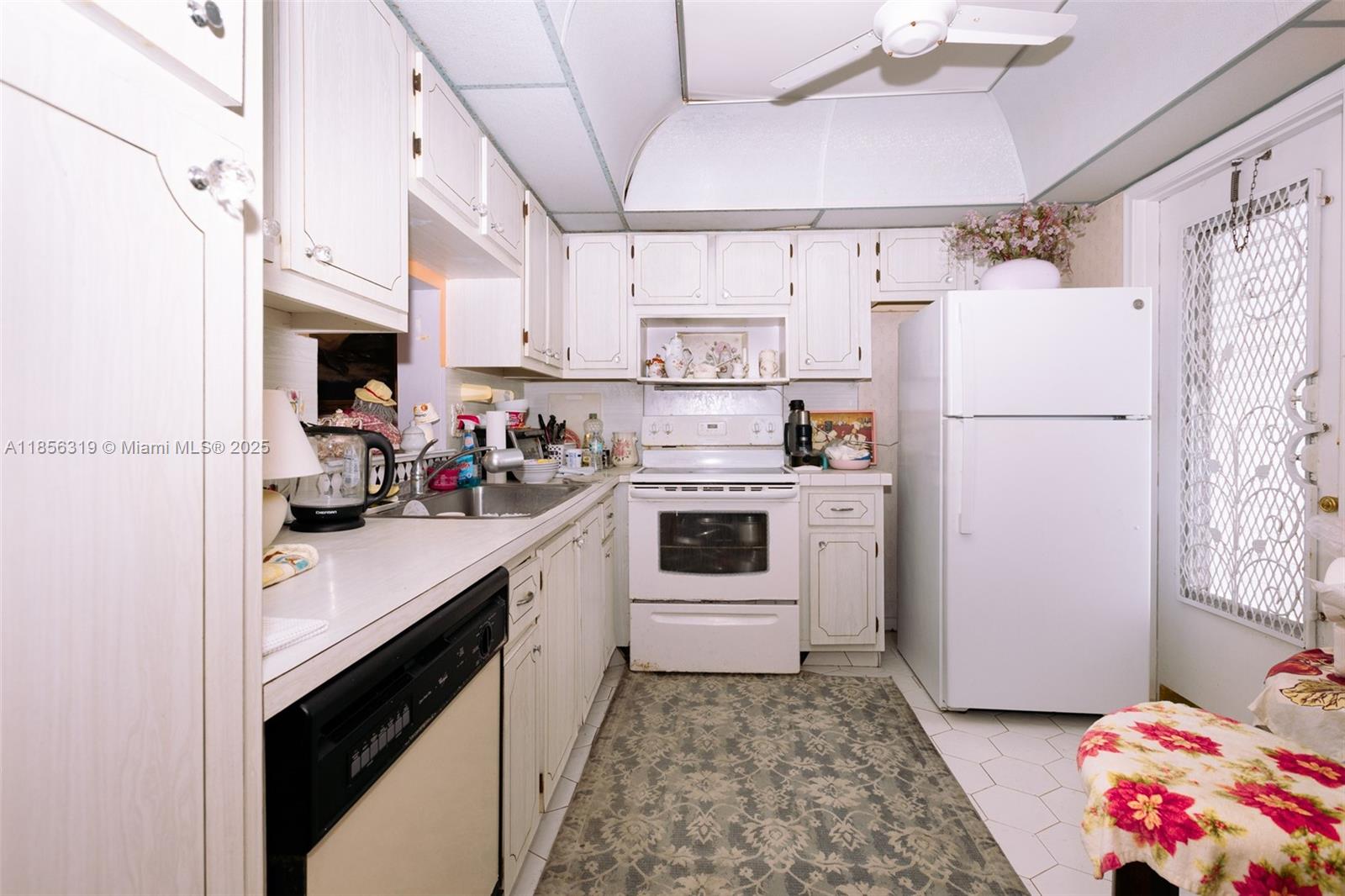 619 Northeast 14th Avenue, Unit 507 Hallandale Beach, FL 33009 - Photo 7 of 31 a kitchen with a white stove top oven and refrigerator