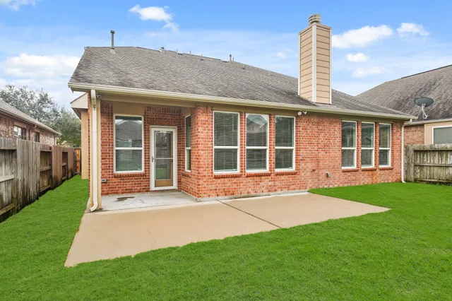 a front view of a house with a garden and yard