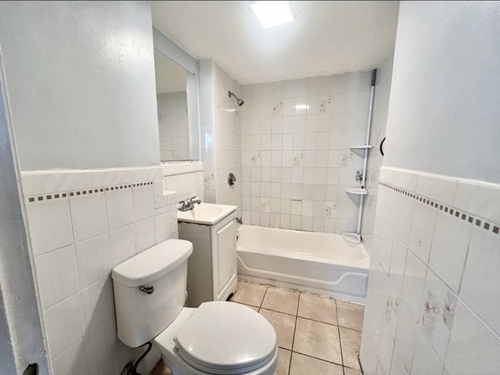 37 Maverick Street, Unit 3 Chelsea, MA 02150 - Photo 7 of 9 a white toilet sitting next to a bath tub and shower