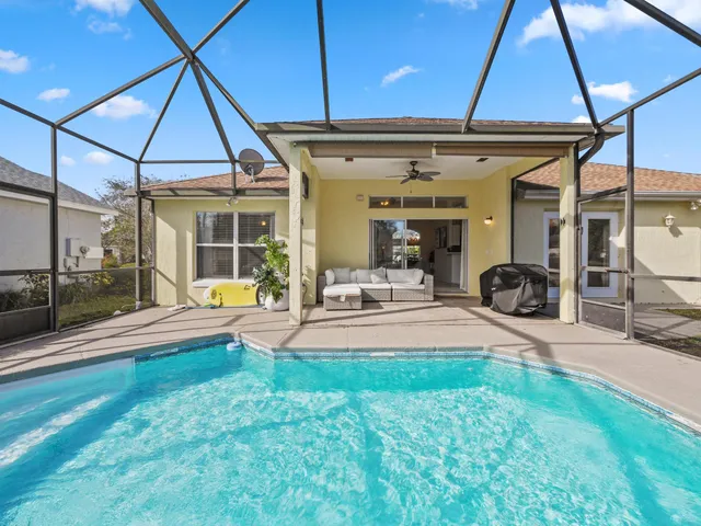 a swimming pool with table and chairs