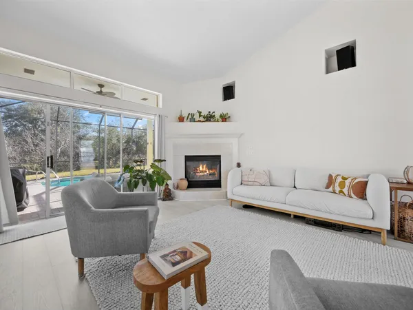 a swimming pool with table and chairs