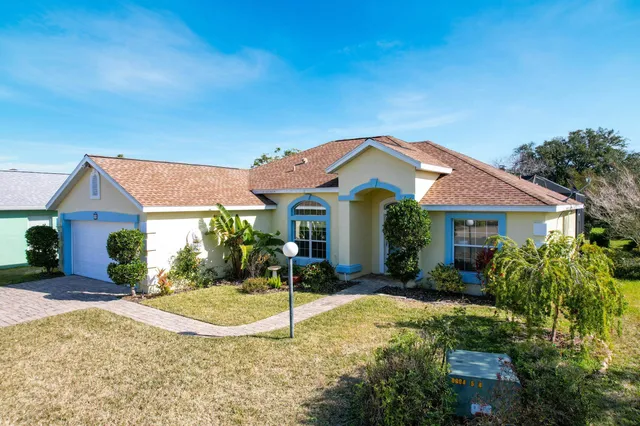 a front view of house with yard and green space
