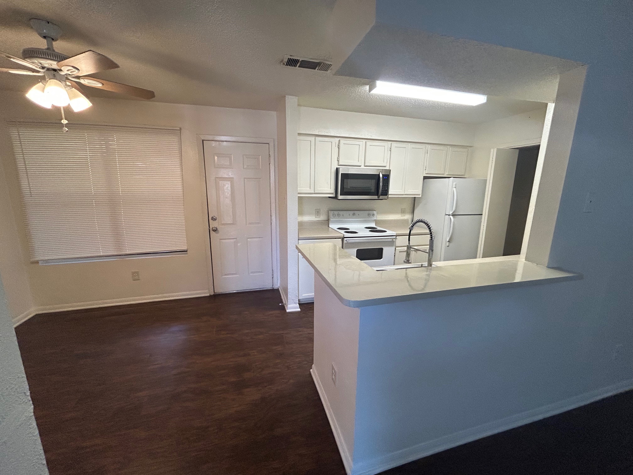 8812 Schick Road, Unit C Austin, TX 78729 - Photo 3 of 12 a kitchen with kitchen island a sink stainless steel appliances and cabinets