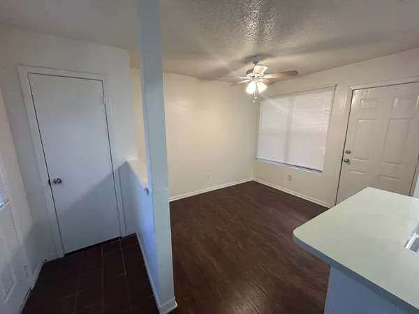 a view of empty room with wooden floor