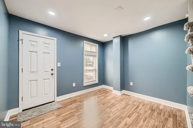 a view of a hallway with wooden floor and entryway