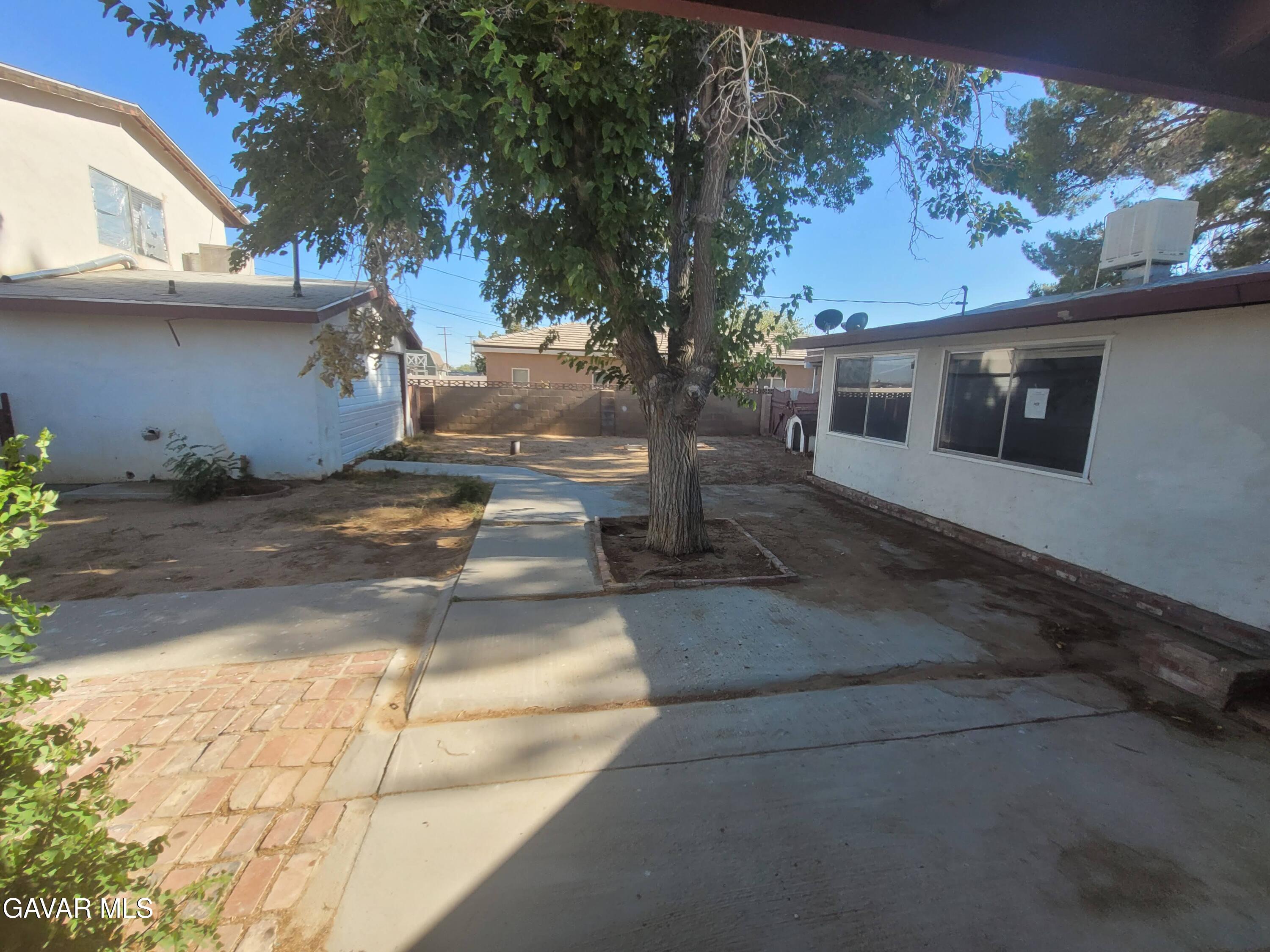 13420 Gilbert Street North Edwards, CA 93523 - Photo 15 of 20 a view of a house with a backyard