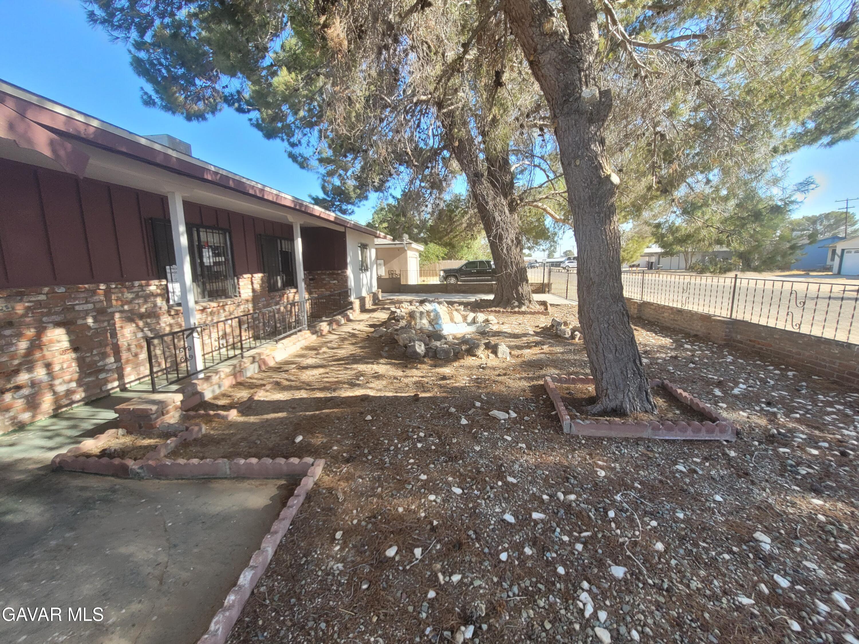 13420 Gilbert Street North Edwards, CA 93523 - Photo 20 of 20 a view of a backyard with large tree