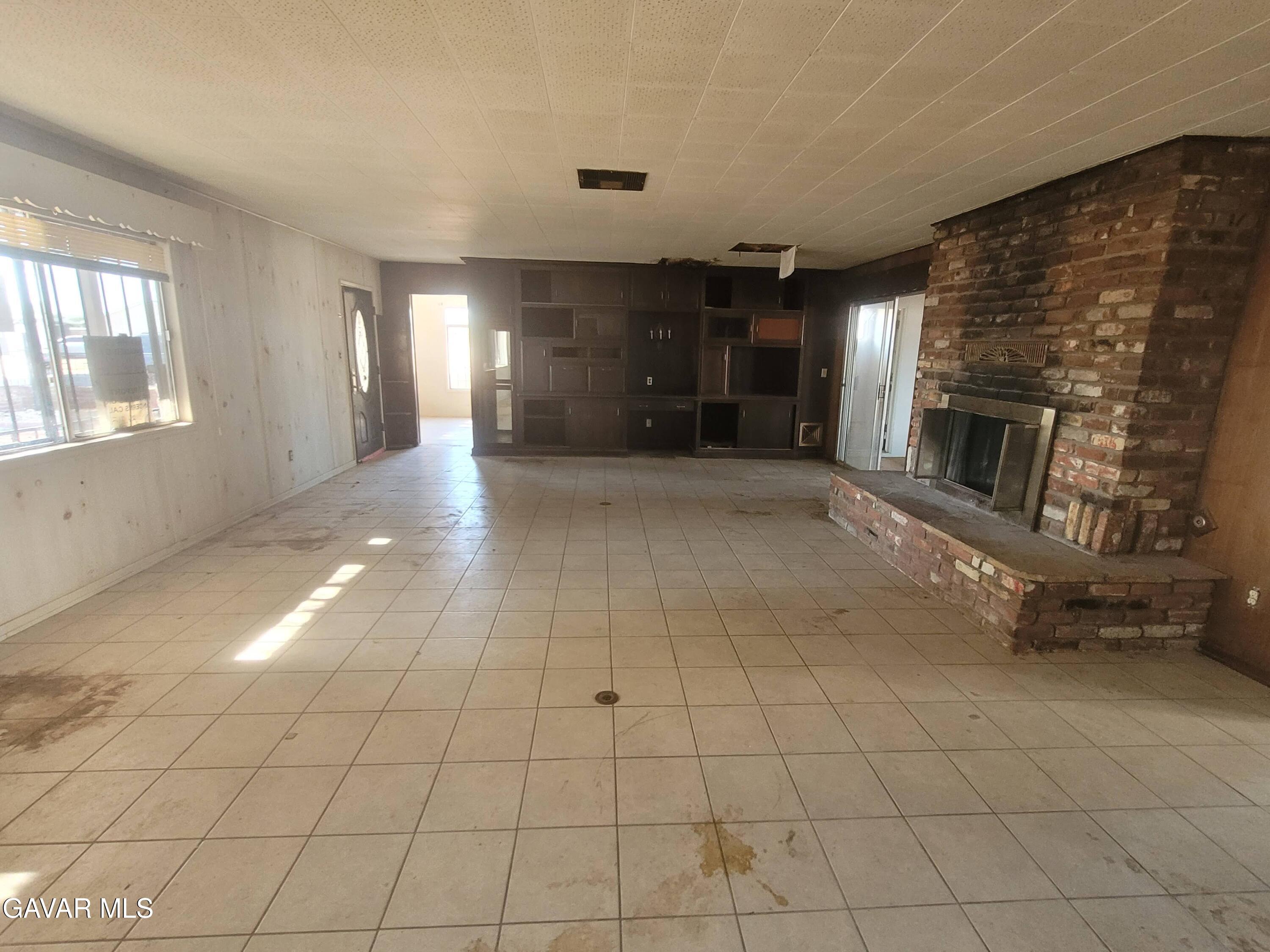 13420 Gilbert Street North Edwards, CA 93523 - Photo 3 of 20 a view of a livingroom with an empty space and a fireplace
