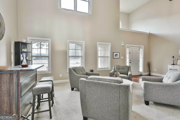 a view of kitchen with dining table chairs refrigerator and microwave