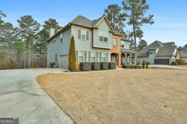 a front view of a house with a yard and garage