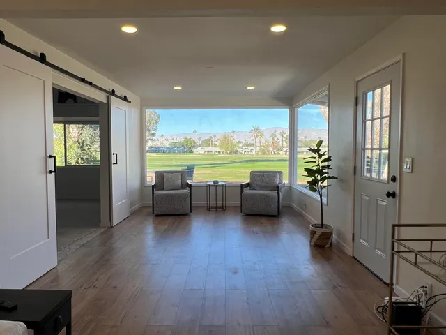 a living room with furniture and a large window