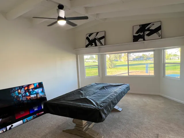 a bedroom with a bed and a tv