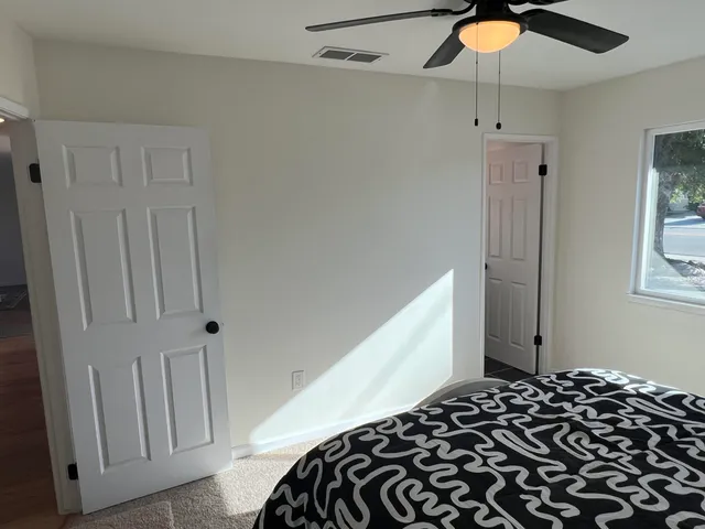 a bedroom with a bed and a window