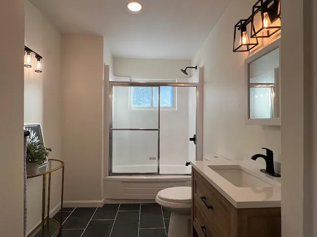 a bathroom with a sink toilet and shower