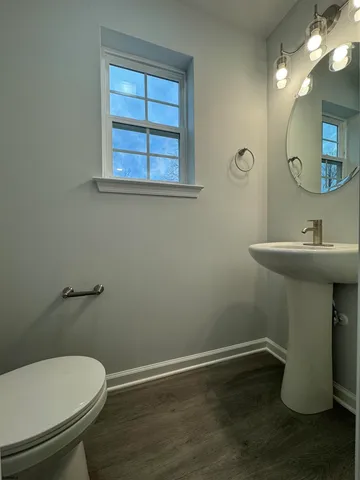 a bathroom with a sink toilet and a mirror