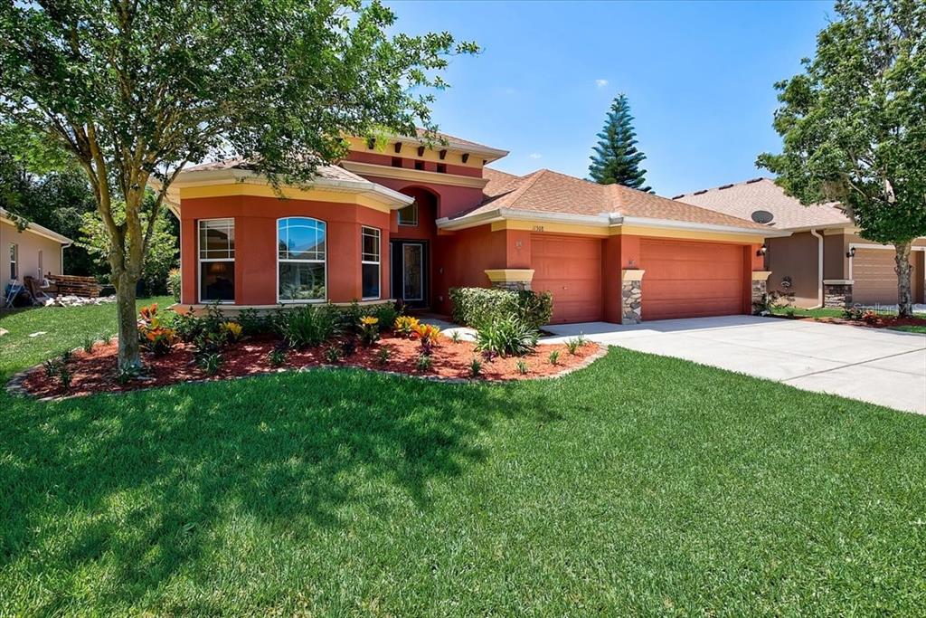 11308 Tayport Loop New Port Richey, FL 34654 - Photo 1 of 1 Gorgeous, stone exterior walls with stone landscape borders