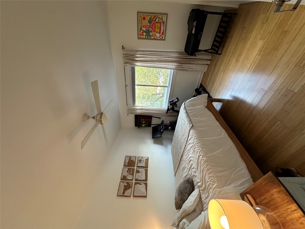 2200 Dickson Drive, Unit 216 Austin, TX 78704 - Photo 3 of 10 a bedroom with a bed and wooden floor