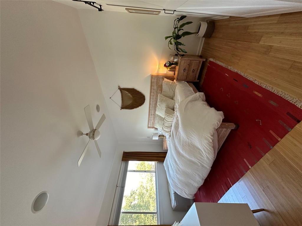 2200 Dickson Drive, Unit 216 Austin, TX 78704 - Photo 5 of 10 a spacious bedroom with a bed and wooden floor