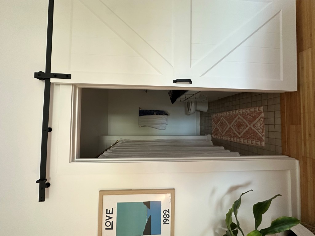 2200 Dickson Drive, Unit 216 Austin, TX 78704 - Photo 6 of 10 a view of a hallway with wooden floor and a cabinet