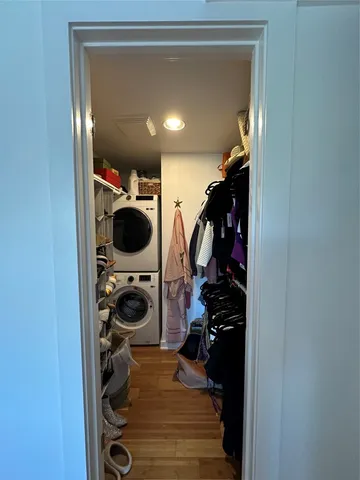 a view of walk in closet with clothes and shoes
