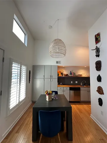 a view of a dining room with a table and chairs
