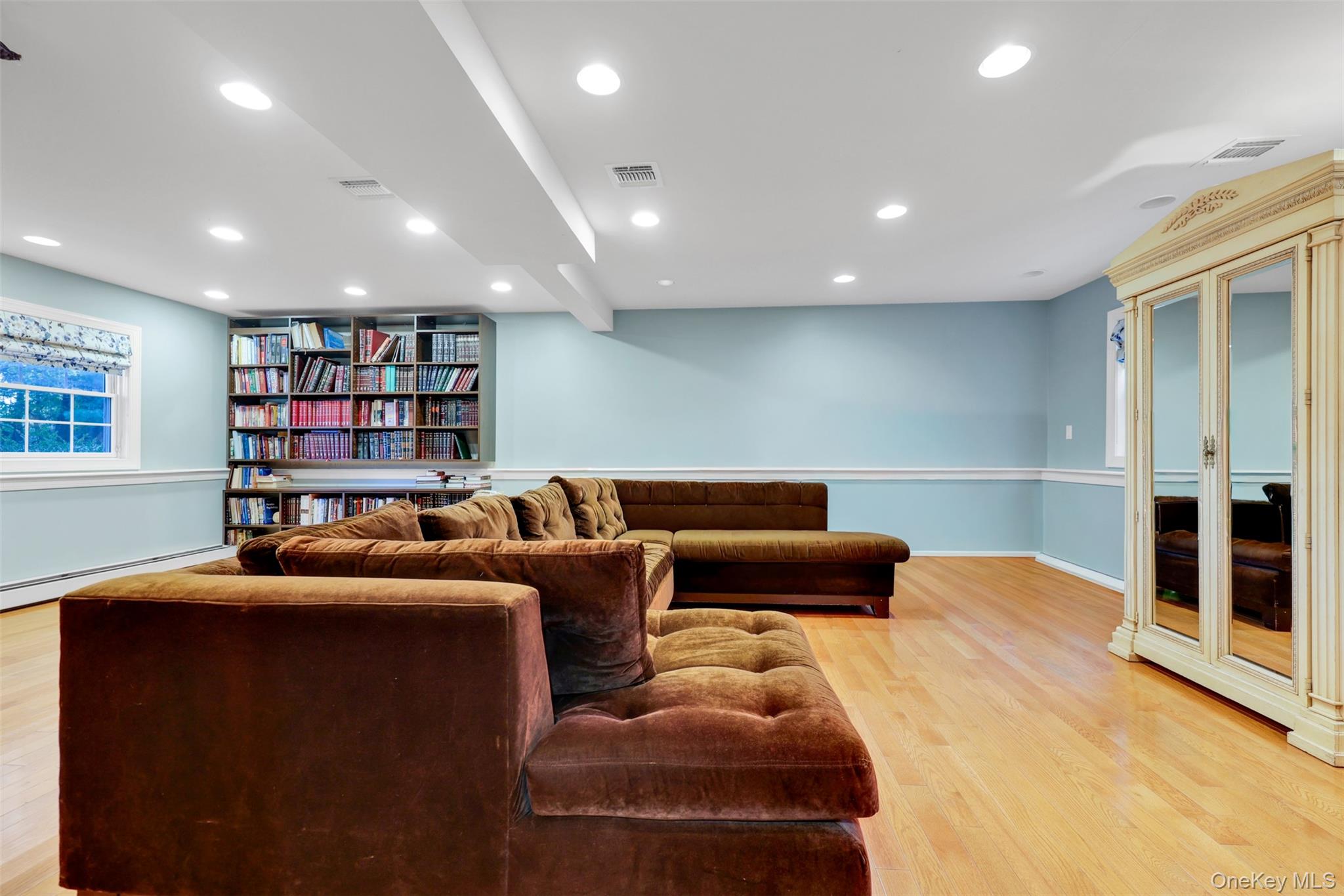 3 Kakiat Lane Spring Valley, NY 10977 - Photo 35 of 44 a living room with furniture and a book shelf