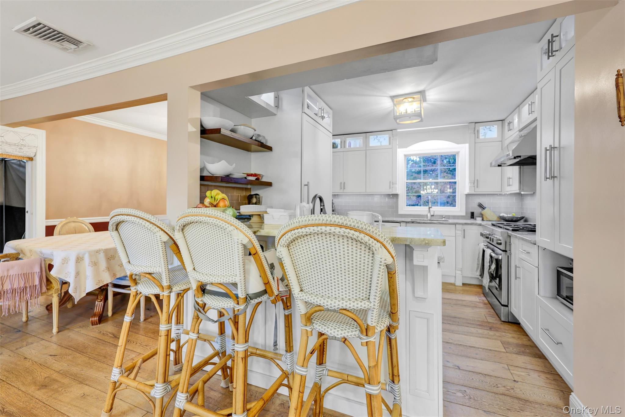 3 Kakiat Lane Spring Valley, NY 10977 - Photo 8 of 44 a kitchen with stainless steel appliances granite countertop a sink a stove cabinets dining table and chairs