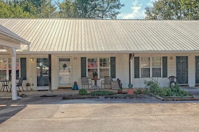 683 Grant Street, Unit G Clarkesville, GA 30523 - Photo 1 of 1 a front view of a house with garden