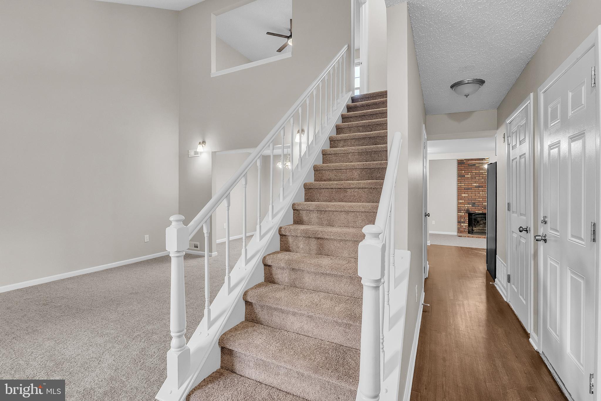 55 Hamilton Street Swedesboro, NJ 08085 - Photo 13 of 48 a view of staircase with lots of frames on wall and wooden floor