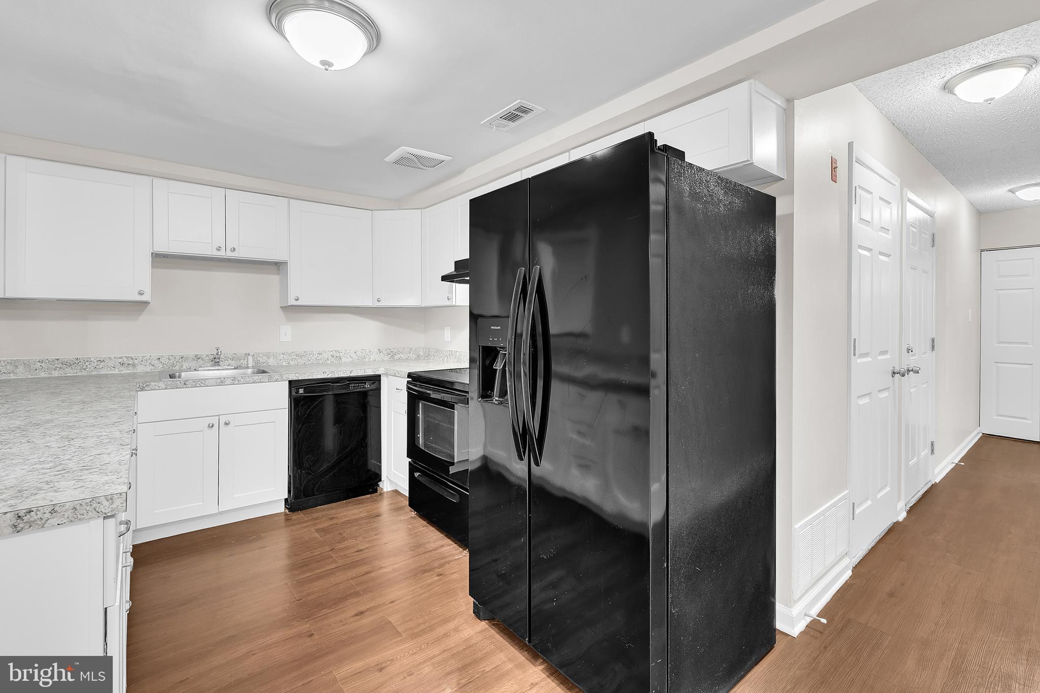 55 Hamilton Street Swedesboro, NJ 08085 - Photo 23 of 48 a kitchen with a refrigerator and a sink