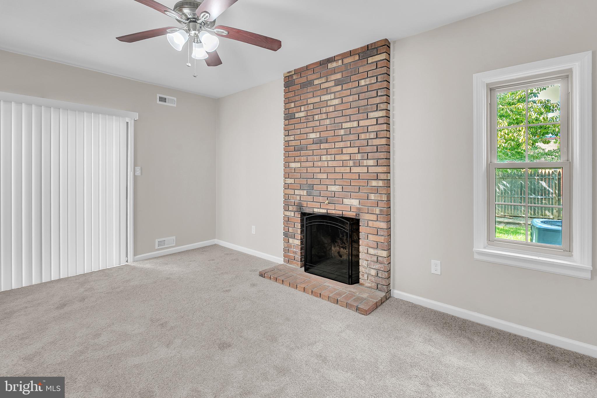55 Hamilton Street Swedesboro, NJ 08085 - Photo 28 of 48 an empty room with windows fireplace and fan