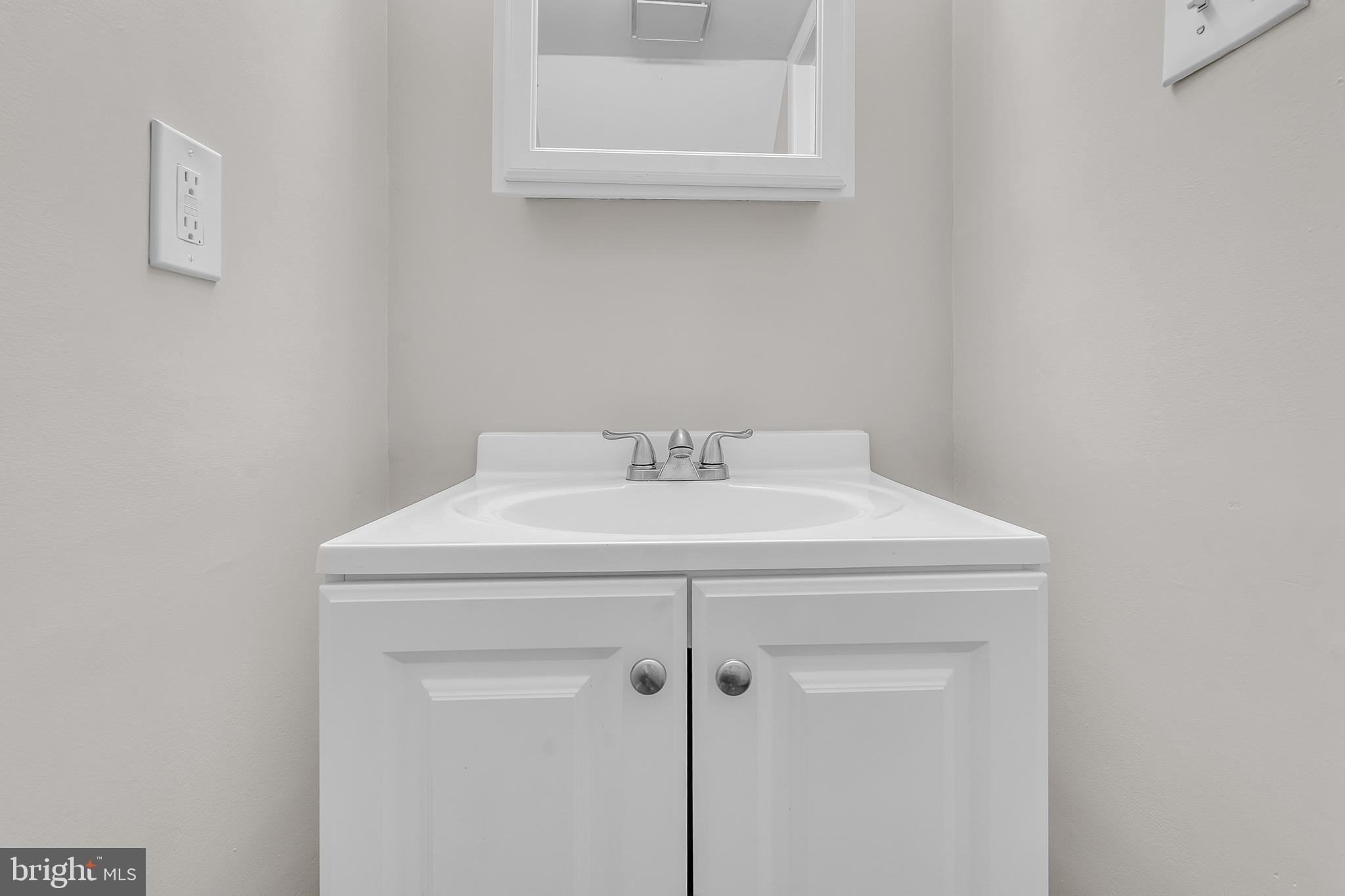 55 Hamilton Street Swedesboro, NJ 08085 - Photo 42 of 48 a bathroom with a sink and a mirror