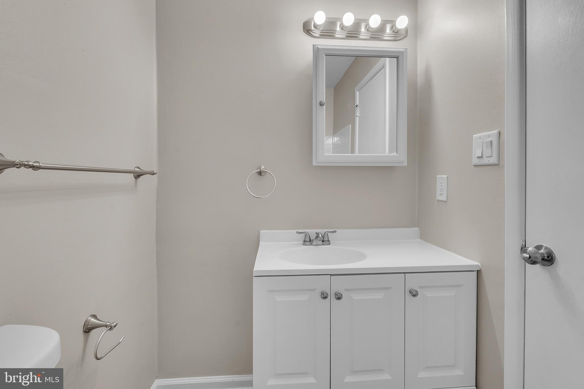 55 Hamilton Street Swedesboro, NJ 08085 - Photo 46 of 48 a bathroom with a sink a toilet and mirror