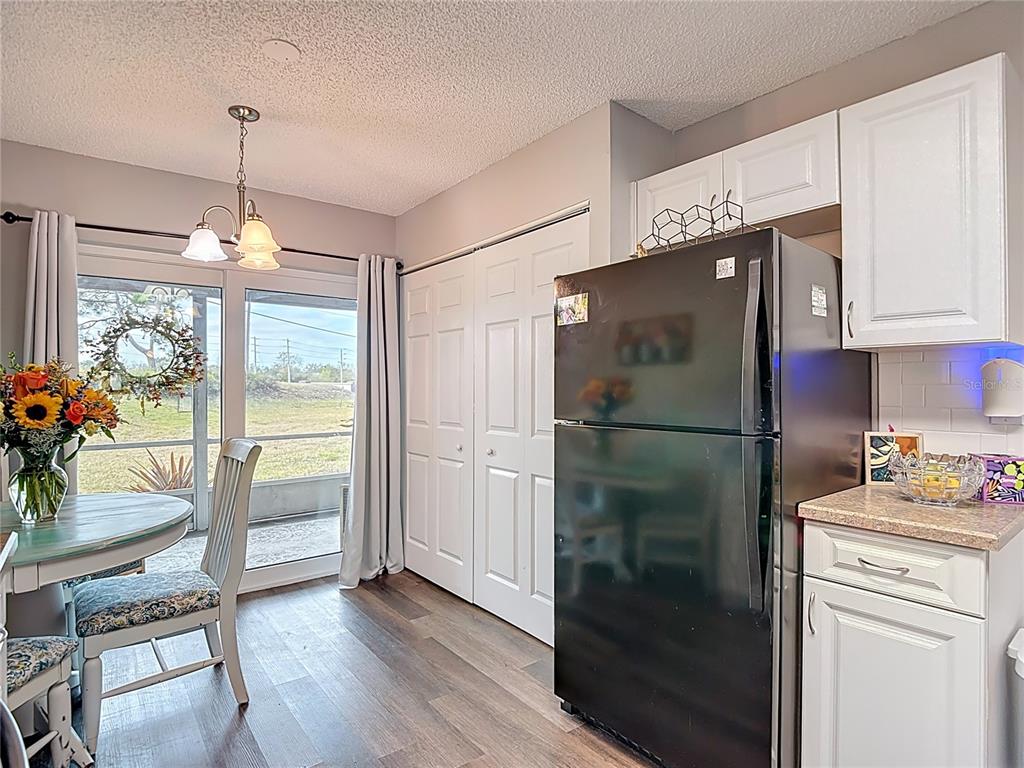 7828 Hardwick Drive, Unit 916 New Port Richey, FL 34653 - Photo 14 of 40 a kitchen with a refrigerator and countertop wooden floor