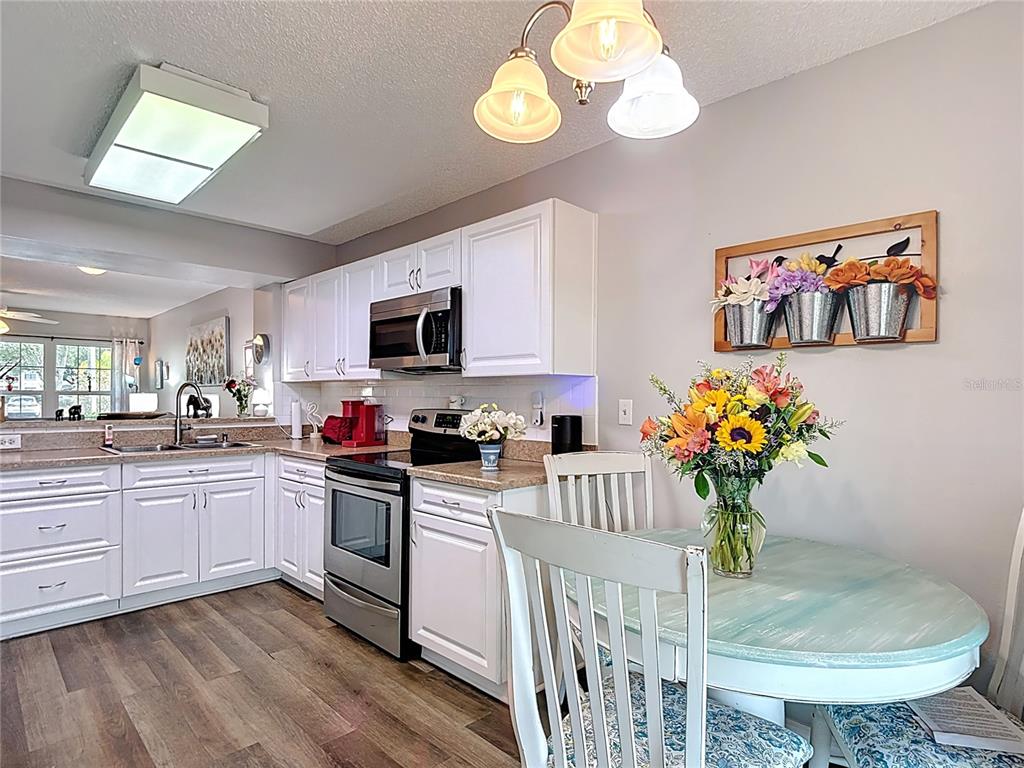 7828 Hardwick Drive, Unit 916 New Port Richey, FL 34653 - Photo 16 of 40 a kitchen with cabinets a sink and appliances