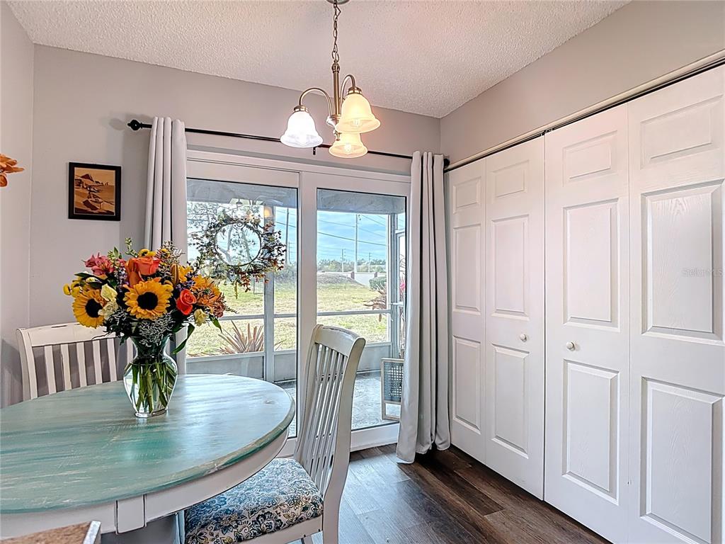 7828 Hardwick Drive, Unit 916 New Port Richey, FL 34653 - Photo 18 of 40 a dining room with furniture a chandelier and wooden floor