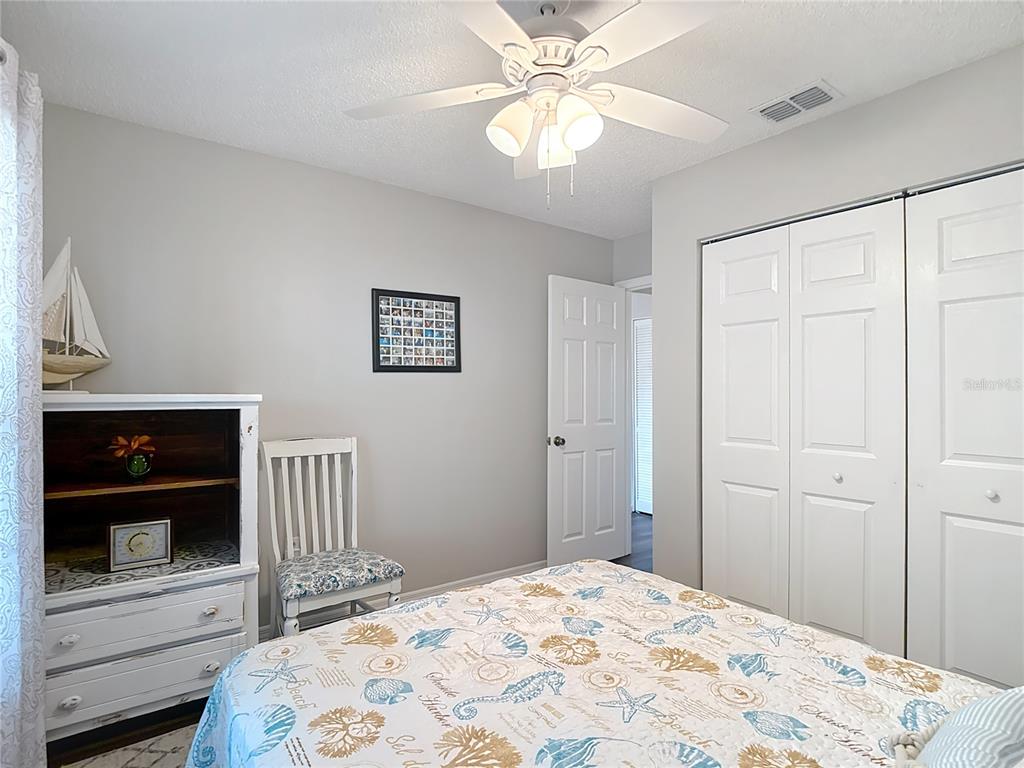 7828 Hardwick Drive, Unit 916 New Port Richey, FL 34653 - Photo 22 of 40 a bedroom with a bed and a window