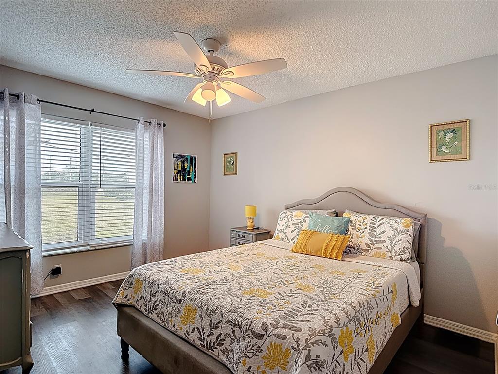 7828 Hardwick Drive, Unit 916 New Port Richey, FL 34653 - Photo 24 of 40 a bedroom with a bed and a chandelier