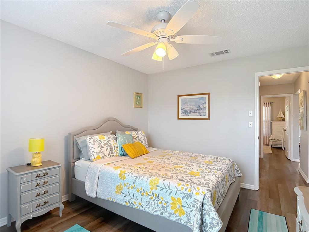 7828 Hardwick Drive, Unit 916 New Port Richey, FL 34653 - Photo 25 of 40 a bedroom with a bed and a chandelier